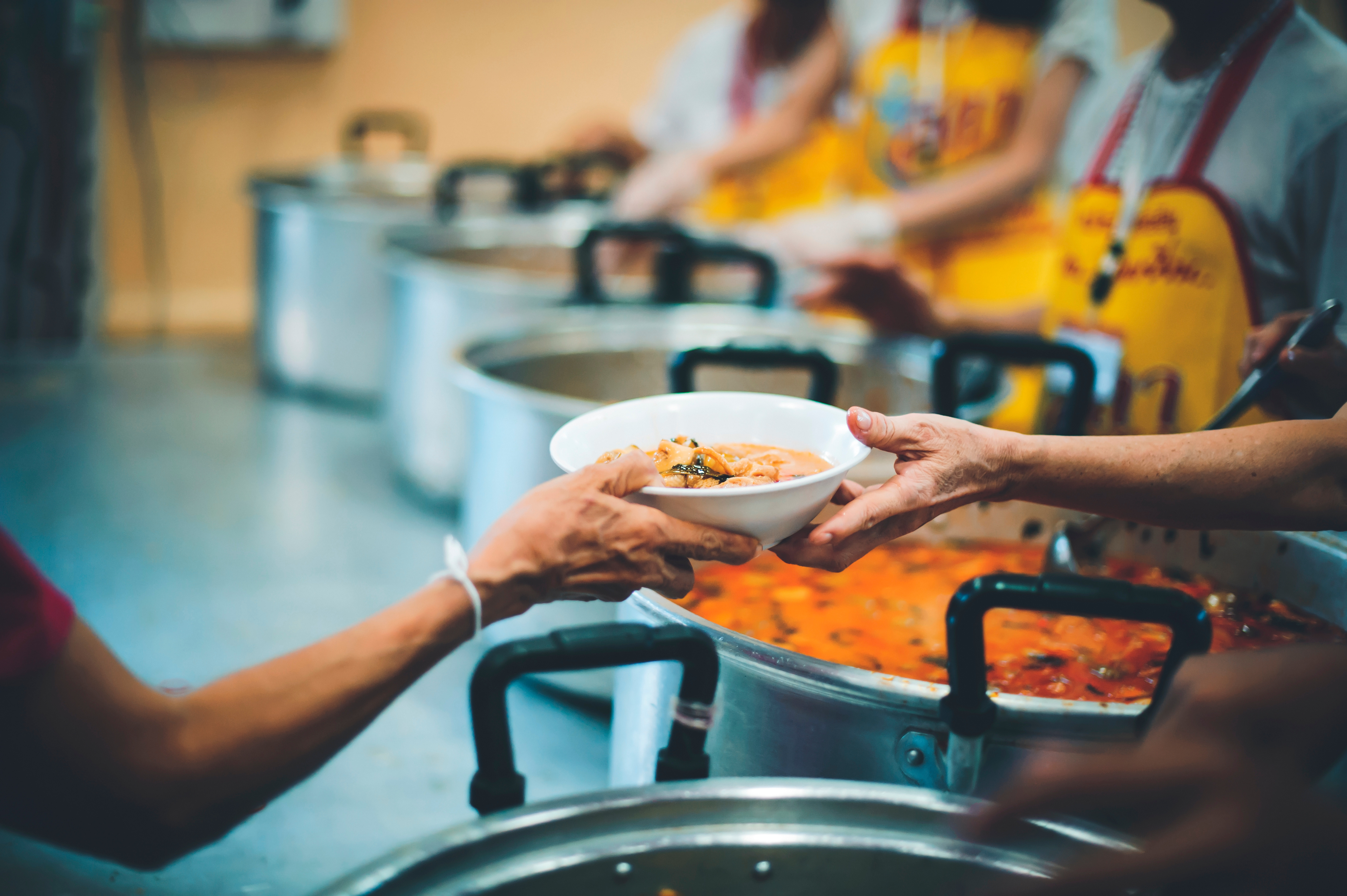 Woman passing food to person in need